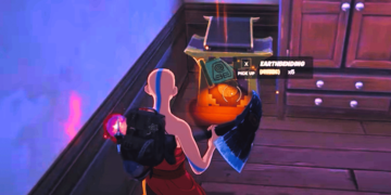 Fortnite disables Earthbending in Avatar crossover event. A screenshot from Fortnite showing a player character about to pick up an Earthbending scroll, with the action prompt "X PICK UP (HOLD)" displayed and a counter indicating there are six scrolls available. The character is illuminated by a faint pink glow, suggesting an in-game effect or power-up, set against a room interior with wooden flooring and a closed wooden door.