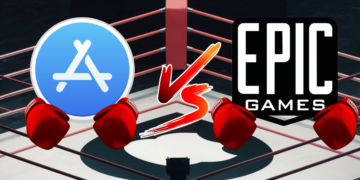 Apple denies breaching court order in ongoing Epic Games dispute. The image is a creative representation of a competition or battle between two major companies in the digital market, specifically in gaming and app distribution. On the left, there is an icon representing Apple, characterized by the stylized white "A" of the App Store logo, with a blue background. The Apple logo has a pair of cartoonish red boxing gloves, indicating readiness for a fight or competition. On the right side, there is a similar icon for Epic Games, known for its popular video game titles and the Epic Games Store. Its logo is black and white with boxing gloves identical to those on the Apple icon. In the center, there is a stylized "VS" for "versus," emphasizing the competitive aspect of the image. The background features a boxing ring, reinforcing the concept of a battle or confrontation between the two entities. This imagery likely alludes to legal or market competition between Apple and Epic Games, perhaps referencing a lawsuit or a dispute over app store policies and practices.